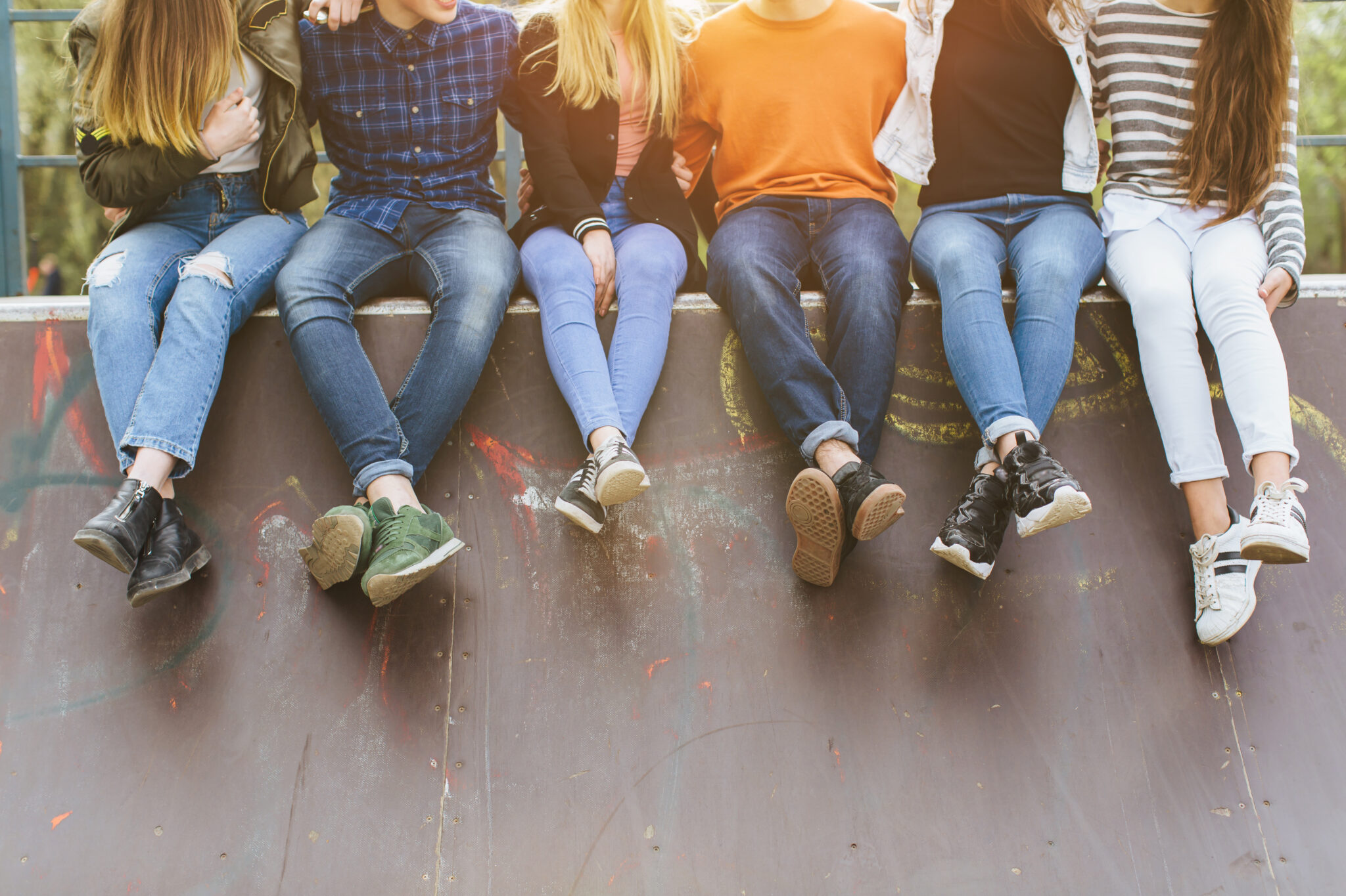 Teens sitting on concrete wall