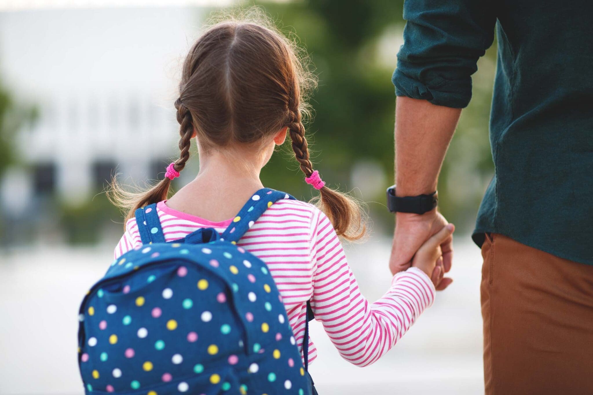 Child with father holding hands