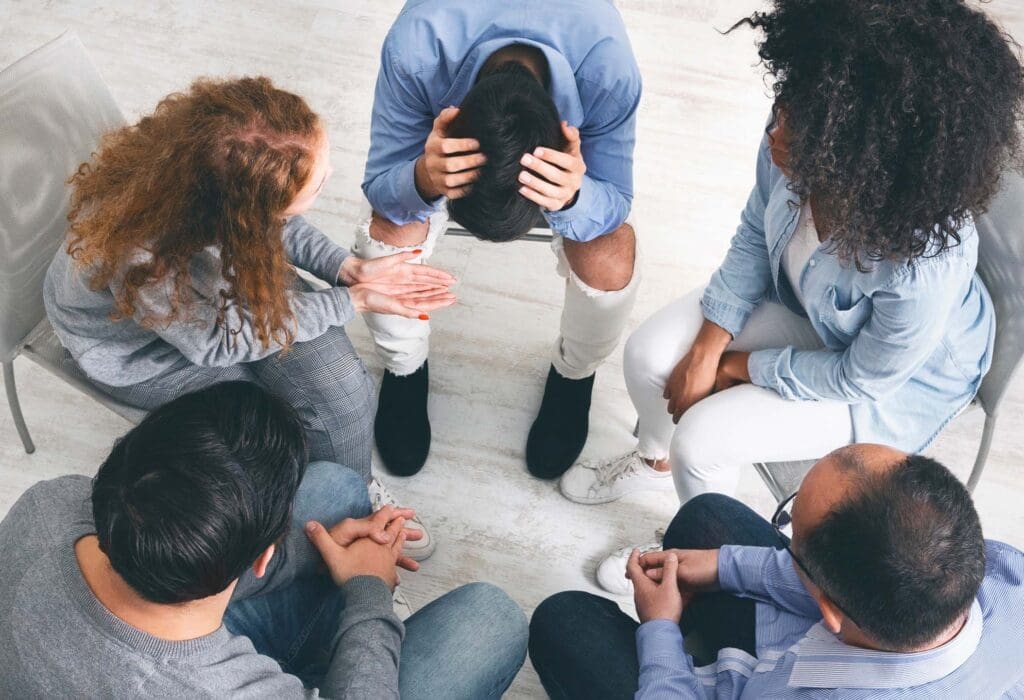 Nervous breakdown. Depressed man suffering from lots of problems, sharing them at support group meeting, top view